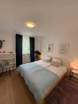a bedroom with a large bed and a window at Luxury Residence Res in Ljubljana