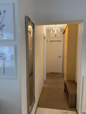 a hallway with a mirror and a hallway leading into a room at Luxury Residence Res in Ljubljana