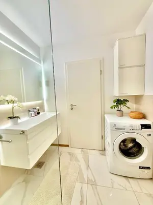 a bathroom with a washing machine and a sink at Luxury Residence Res in Ljubljana