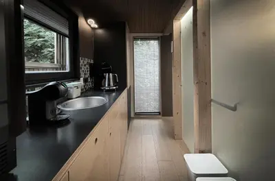 a bathroom with a sink and a toilet and a window at Moon - Tiny house from Callin Wines in Sežana