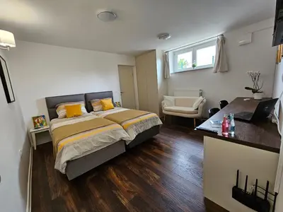 a bedroom with a bed and a chair in it at APARTMA FIREFLY1 in Ljubljana