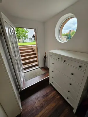 a room with a dresser and a mirror and stairs at APARTMA FIREFLY1 in Ljubljana