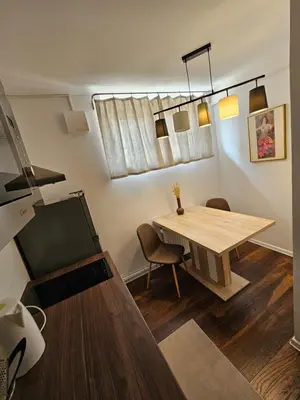 a dining room with a wooden table and chairs at APARTMA FIREFLY1 in Ljubljana