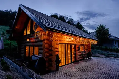 a log cabin with christmas lights on it at Chalet -VV in Podčetrtek