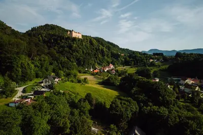 a village on a hill with a castle on top at Chalet -VV in Podčetrtek