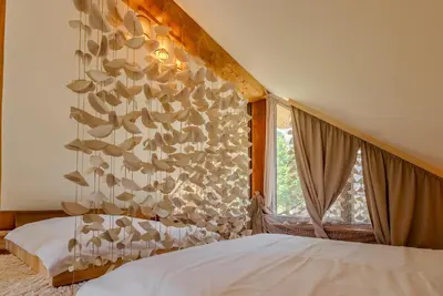 a bedroom with a bed and a window at Chalet -VV in Podčetrtek
