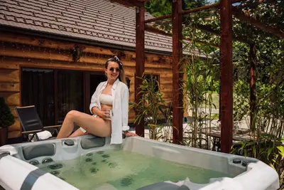 a woman is sitting in a bath tub at Chalet -VV in Podčetrtek