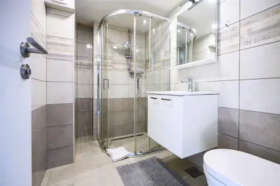 a bathroom with a shower and a toilet at The Wonderful Loft in Ljubljana