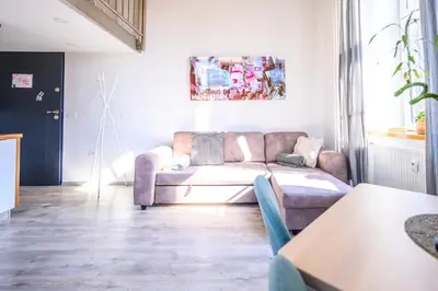 a living room with a couch and a table at The Wonderful Loft in Ljubljana