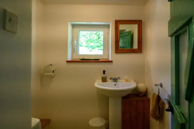 a bathroom with a sink and a window at Stara Hiša in Log Čezsoški