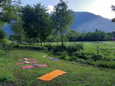 a group of kites laying on the grass in a field at Stara Hiša in Log Čezsoški