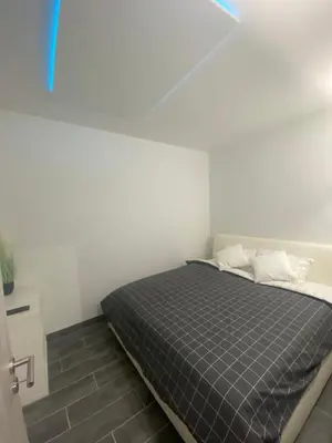a bedroom with a bed in a white room at Lavitas SPA in Moravče