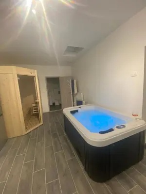 a bathroom with a blue tub in a room at Lavitas SPA in Moravče