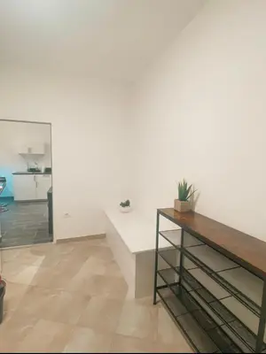 a white room with a bench and a table at Lavitas SPA in Moravče