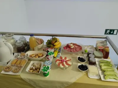 a table with many different types of food on it at Apartma Azurre in Postojna