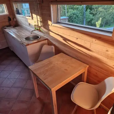 a small table and a sink in a tiny house at Bellevue mini House in Žetale