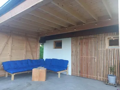 a blue couch sitting inside of a building at Bellevue mini House in Žetale