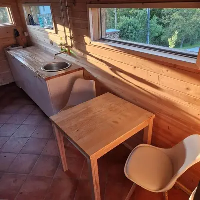 a tiny house with a sink and a table at Bellevue mini House in Žetale
