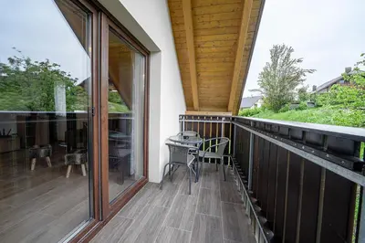 a screened in porch with a table on the deck at Apartmaji Koza in Zgornje Gorje