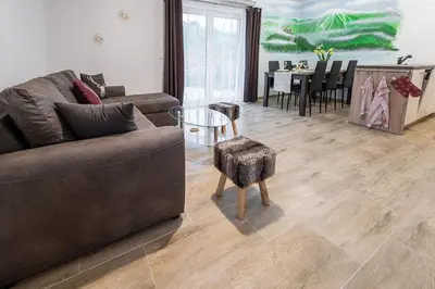 a living room with a couch and a table at Apartmaji Koza in Zgornje Gorje
