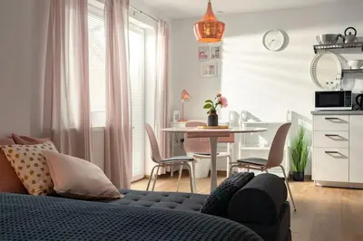 a living room with a couch and a table with chairs at Ljubljana studio with FREE parking, Washer & Dryer in Ljubljana