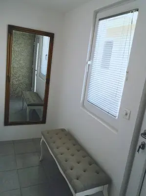a mirror in a room with a bench and a window at Ljubljana studio with FREE parking, Washer & Dryer in Ljubljana