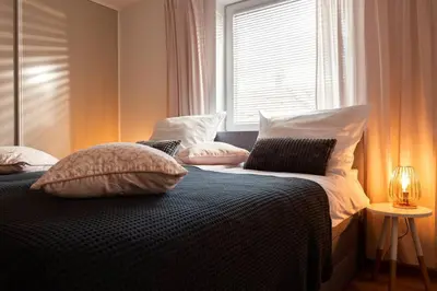 a bedroom with a bed with pillows and a window at Ljubljana studio with FREE parking, Washer & Dryer in Ljubljana