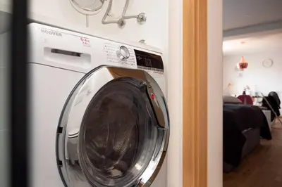 a white washing machine in a room with at Ljubljana studio with FREE parking, Washer & Dryer in Ljubljana
