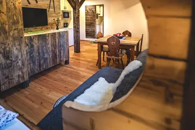 a living room with a couch and a table at Tourist Farm Šenkova Domačija in Zgornje Jezersko
