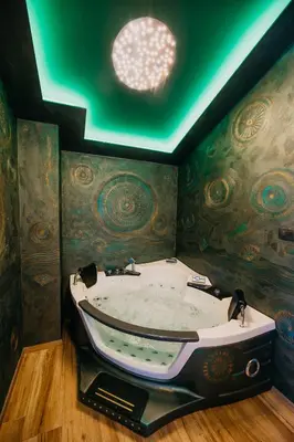 a large bath tub in a room with a ceiling at Villa Sunset Pool & Spa apartments in Zgornje Škofije
