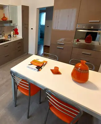a kitchen with a table with an orange pot on it at Apartma Vista montana in Kobarid