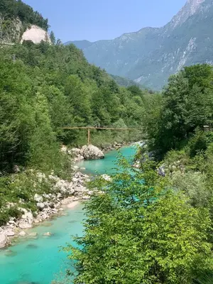 a view of a river with a bridge in the background at Apartma Vista montana in Kobarid