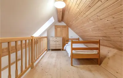 a attic bedroom with a bed and a wooden ceiling at 1 Bedroom Stunning Apartment In Col in Zoll