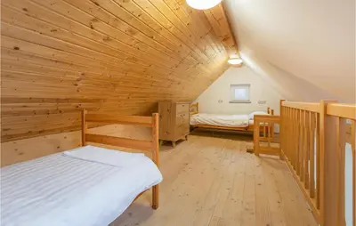a room with two beds and a wooden ceiling at 1 Bedroom Stunning Apartment In Col in Zoll