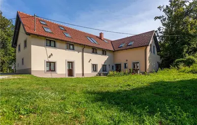 a large white house with a red roof at 1 Bedroom Stunning Apartment In Col in Zoll