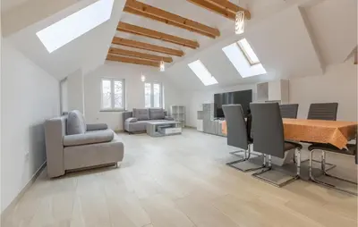a living room with a dining table and chairs at 1 Bedroom Stunning Apartment In Col in Zoll