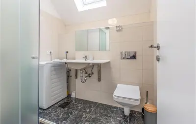 a bathroom with a toilet and a sink at 1 Bedroom Nice Apartment In Col in Zoll