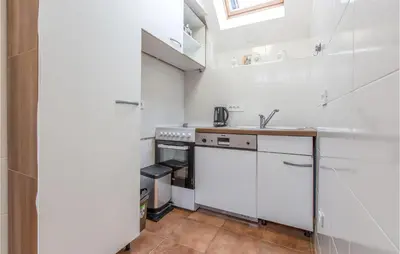a small kitchen with a sink and a stove at 1 Bedroom Nice Apartment In Col in Zoll