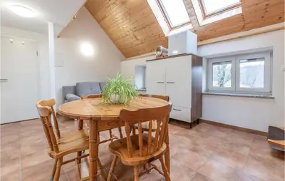 a kitchen and dining room with a table and chairs at 1 Bedroom Nice Apartment In Col in Zoll