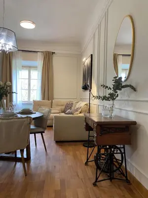 a living room with a couch and a table at Apartment Breg - Old town river in Ljubljana