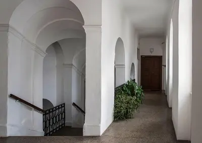 a hallway of a building with white walls and arches at Apartment Breg - Old town river in Ljubljana