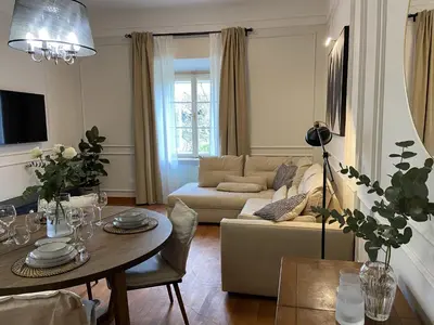 a living room with a table and a couch at Apartment Breg - Old town river in Ljubljana