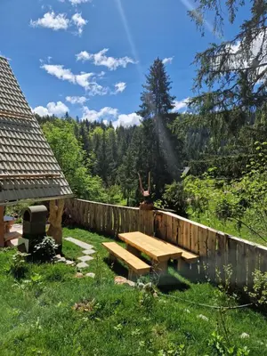 a picnic table in a yard with a fence at OTO`S CABIN in Radovljica