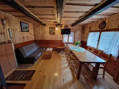 a living room with a table and a couch at OTO`S CABIN in Radovljica