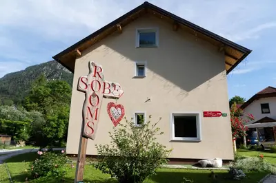 a house with a sign that says red so loved at Gorski biser in Mojstrana