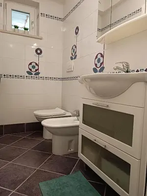 a bathroom with a toilet and a sink and a toilet at Apartma 31 in Nova Gorica