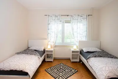 two beds in a room with a window at Apartment Rozalija Žirovnica in Žirovnica