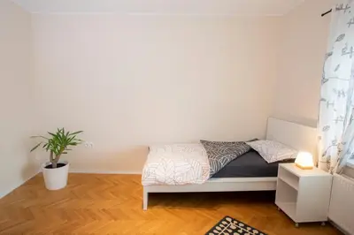 a small bedroom with a bed and a potted plant at Apartment Rozalija Žirovnica in Žirovnica