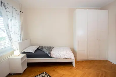 a small bedroom with a bed and a window at Apartment Rozalija Žirovnica in Žirovnica