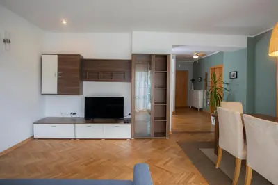 a living room with a television and a dining room at Apartment Rozalija Žirovnica in Žirovnica